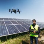 operador voando drone em usina fotovoltaica para inspeção de painéis solares